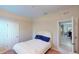 Bedroom with white headboard, blue pillows, and view of dining room at 116 Navigation Cir # 106, Osprey, FL 34229