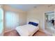 Cozy bedroom with a white frame queen bed, plush carpeting, and a view to the dining room at 116 Navigation Cir # 106, Osprey, FL 34229