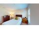Bedroom with wood furniture, neutral bedding, and a bright window at 116 Navigation Cir # 106, Osprey, FL 34229