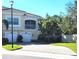 Well-maintained Mediterranean-style townhome with brick-paved driveway, garage and mature landscaping at 116 Navigation Cir # 106, Osprey, FL 34229