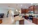 Open kitchen with stainless steel appliances, granite countertops, and dark wood cabinets with island at 116 Navigation Cir # 106, Osprey, FL 34229