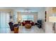 Bright living room with tile floors, ceiling fan, large windows, and comfortable seating arrangement at 116 Navigation Cir # 106, Osprey, FL 34229