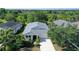 An aerial front view of a single-story home showing the yard, driveway and landscaping at 12133 Forest Park Cir, Bradenton, FL 34211