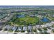 The aerial view showcases a home surrounded by mature trees, ponds, and manicured lawns at 12133 Forest Park Cir, Bradenton, FL 34211