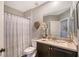 Bathroom featuring a sink, cabinet, mirror, toilet, shower with a shower curtain, and unique heart decor at 12133 Forest Park Cir, Bradenton, FL 34211