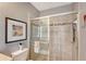 Bathroom featuring tile flooring and an enclosed shower with a towel rack and decorative accent tile at 12133 Forest Park Cir, Bradenton, FL 34211