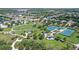 A view of the community park, with tennis courts and walking paths surrounded by mature trees at 12133 Forest Park Cir, Bradenton, FL 34211