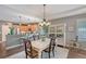 Elegant dining room with hardwood floors, chandelier, and view to the kitchen at 12133 Forest Park Cir, Bradenton, FL 34211