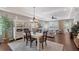 Elegant dining room featuring a stylish chandelier, tray ceiling, and seamless access to the living area at 12133 Forest Park Cir, Bradenton, FL 34211