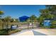Entrance to a fenced dog park with shaded seating in a dog-friendly community at 12133 Forest Park Cir, Bradenton, FL 34211
