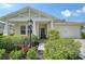 Inviting single-Gathering home with a lovely front porch, lush greenery, and a well-maintained lawn at 12133 Forest Park Cir, Bradenton, FL 34211