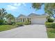 Inviting single-Gathering home with a well-maintained lawn, lush greenery, and a two-car garage at 12133 Forest Park Cir, Bradenton, FL 34211