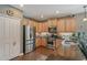 Kitchen with stainless steel appliances, light wood cabinets, and granite countertops at 12133 Forest Park Cir, Bradenton, FL 34211