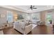 Bright and airy living room featuring hardwood floors, neutral tones, and a ceiling fan at 12133 Forest Park Cir, Bradenton, FL 34211