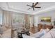 Comfortable living room with a ceiling fan, hardwood floors, and a stylish zebra rug at 12133 Forest Park Cir, Bradenton, FL 34211