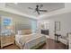 Cozy main bedroom with hardwood floors, a ceiling fan, and an ensuite bathroom at 12133 Forest Park Cir, Bradenton, FL 34211
