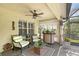 Covered patio with cushioned seating, a ceiling fan, shutters, and a small bar area at 12133 Forest Park Cir, Bradenton, FL 34211