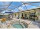 Enclosed patio featuring outdoor dining, a spa, and a covered seating area with curtains at 12133 Forest Park Cir, Bradenton, FL 34211