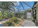 The screened lanai has pavers, lush landscaping, and offers a relaxing outdoor living space at 12133 Forest Park Cir, Bradenton, FL 34211