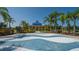 Community splash pad with blue wave patterns and shaded pavilion, surrounded by palm trees at 12133 Forest Park Cir, Bradenton, FL 34211