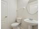 Clean half bathroom featuring a modern toilet and sink and tiled floors at 12358 Destiny Dr, Venice, FL 34292