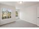 Bright bedroom with carpet, two windows overlooking exterior landscape at 12358 Destiny Dr, Venice, FL 34292