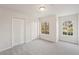 Bedroom featuring carpeted floors, dual closets, and two windows with views to outside at 12358 Destiny Dr, Venice, FL 34292