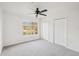 Bedroom featuring carpeted floors, a window with outside views, and dual closets at 12358 Destiny Dr, Venice, FL 34292