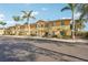 Two-story townhomes with tropical landscaping and sunny yellow exterior paint at 12358 Destiny Dr, Venice, FL 34292