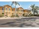 Inviting two-story townhomes with tropical landscaping and sunny yellow exterior at 12358 Destiny Dr, Venice, FL 34292