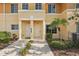 Close up of townhome exterior with landscaping and walkway to the front door at 12358 Destiny Dr, Venice, FL 34292