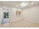 Bright living room featuring tile flooring, a view to the lanai, and a pass-through to the kitchen at 12358 Destiny Dr, Venice, FL 34292