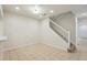 Spacious living room with tile flooring and a staircase leading to the upper level at 12358 Destiny Dr, Venice, FL 34292