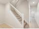 Carpeted staircase with white railing leading to the second floor at 12358 Destiny Dr, Venice, FL 34292