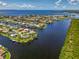 Highlighted aerial view of waterfront homes nestled along canals, docks, and a serene neighborhood setting at 127 Colonial Sw St, Port Charlotte, FL 33952