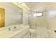 Bright bathroom featuring a vanity, commode, and shower-tub combination at 127 Colonial Sw St, Port Charlotte, FL 33952