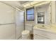Bright bathroom featuring a vanity, commode, and glass-enclosed shower at 127 Colonial Sw St, Port Charlotte, FL 33952