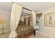 Bedroom featuring a four-poster bed, decorative linens and decor, and a view to the pool at 127 Colonial Sw St, Port Charlotte, FL 33952