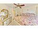 Bedroom featuring a decorative bed with floral bedding, a fan and a dresser at 127 Colonial Sw St, Port Charlotte, FL 33952