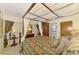 Bedroom showcasing a four-poster bed, decorative linens, an armoire, and side table at 127 Colonial Sw St, Port Charlotte, FL 33952