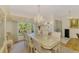 Formal dining room with a chandelier, ample natural light, and seamless flow to other living areas at 127 Colonial Sw St, Port Charlotte, FL 33952