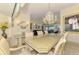 Elegant dining room with chandelier lighting, a large table, and views of the outdoor area at 127 Colonial Sw St, Port Charlotte, FL 33952
