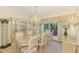 Elegant dining room with a chandelier, large window, and ample seating at 127 Colonial Sw St, Port Charlotte, FL 33952