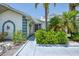 Inviting front entrance with lush tropical landscaping and a well-maintained walkway at 127 Colonial Sw St, Port Charlotte, FL 33952