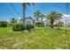 Well-manicured lawn and landscaping showcasing a beautiful facade with an inviting entrance and driveway at 127 Colonial Sw St, Port Charlotte, FL 33952