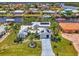 Eye-catching home surrounded by palm trees and landscaping, featuring a well-kept lawn and inviting facade at 127 Colonial Sw St, Port Charlotte, FL 33952