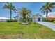 Well-maintained home with lush landscaping, showcasing a pristine lawn and inviting curb appeal at 127 Colonial Sw St, Port Charlotte, FL 33952