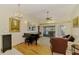 Bright living room with hardwood floors, a chandelier, and easy access to the outdoor pool area at 127 Colonial Sw St, Port Charlotte, FL 33952