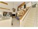 Spacious living room with high ceilings, a ceiling fan, staircase and sliding doors to the back at 127 Colonial Sw St, Port Charlotte, FL 33952