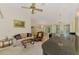 Comfortable living room with a grand piano and seamless transition into the dining area at 127 Colonial Sw St, Port Charlotte, FL 33952